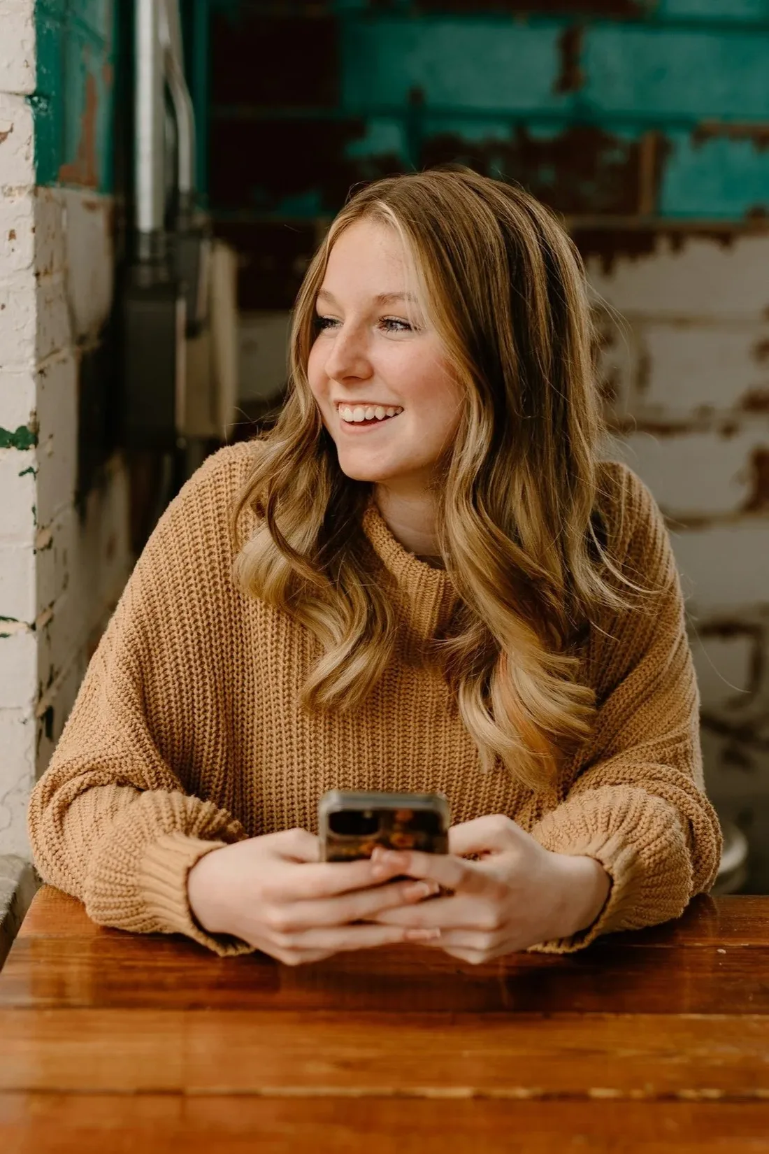 Smiling association member reading a text message on her phone
